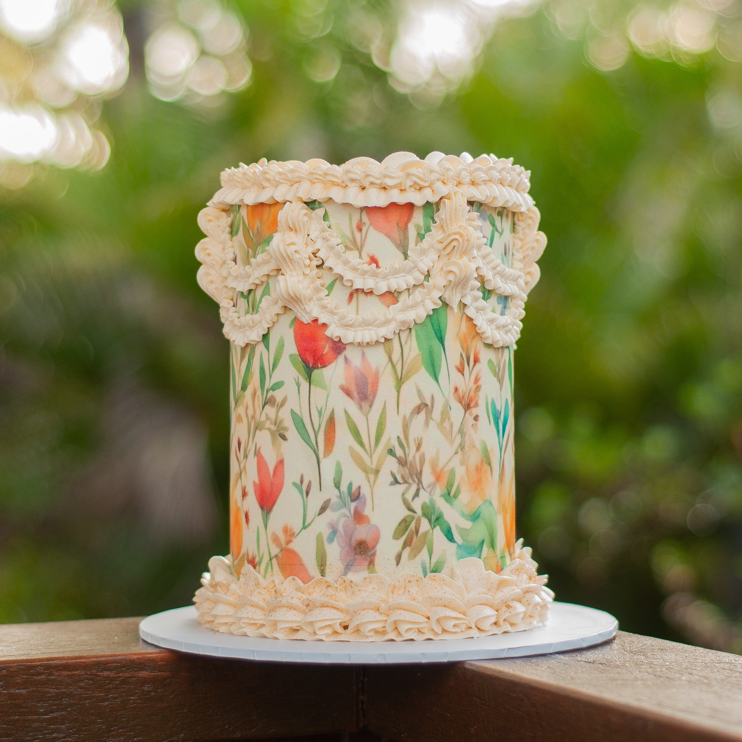 Single-tier wedding cake with vintage-inspired buttercream piping and a vibrant floral edible print design, handcrafted for elegant Brisbane weddings by Caldera.CAKING.